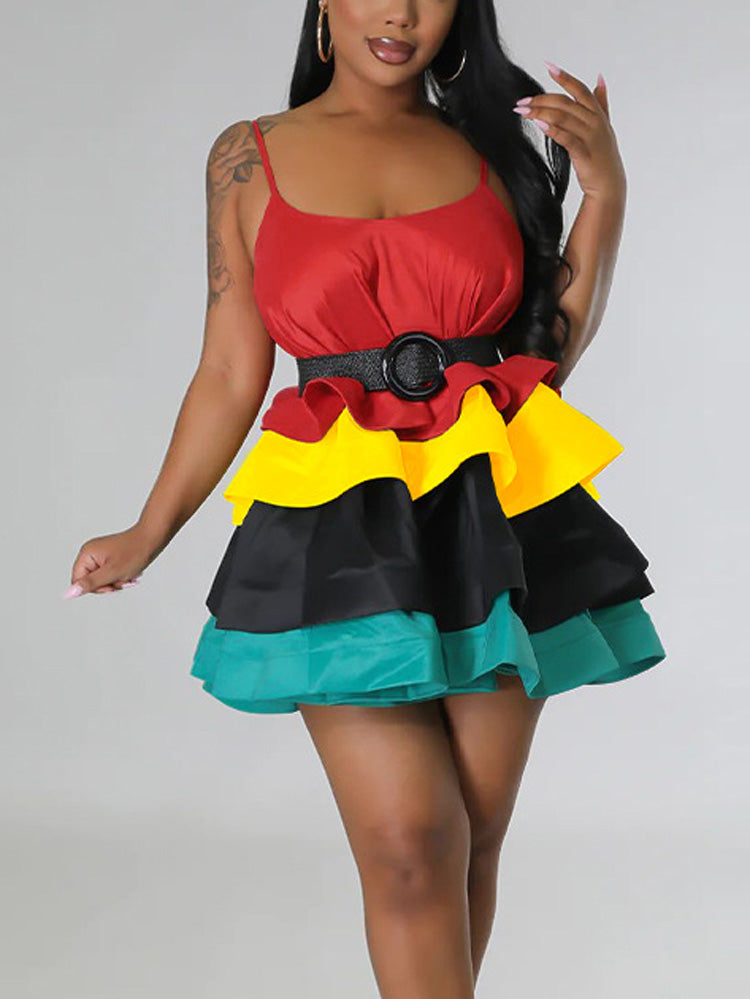 Woman in a red, yellow, black, and teal tiered mini dress with a black belt.