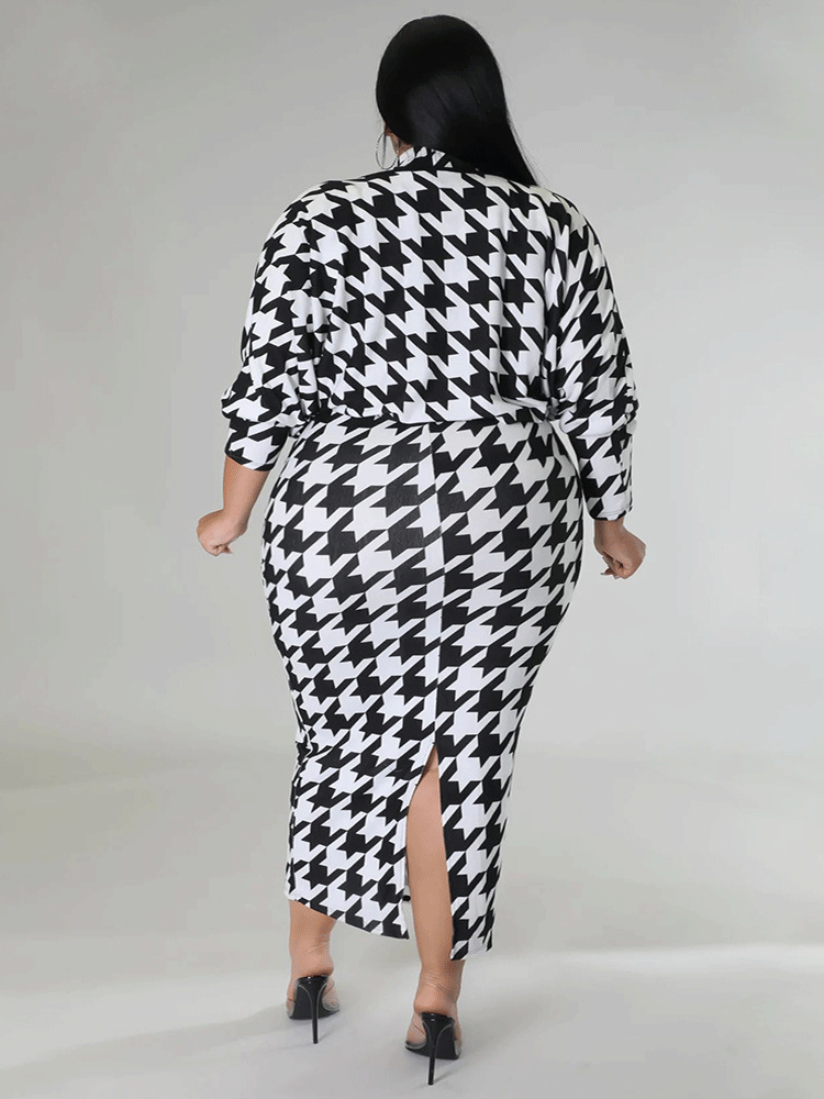 Back view of a plus size model in a black and white houndstooth print mock neck midi dress with a matching jacket