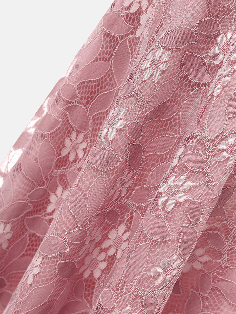 Close-up of the floral lace pattern on a pink midi dress