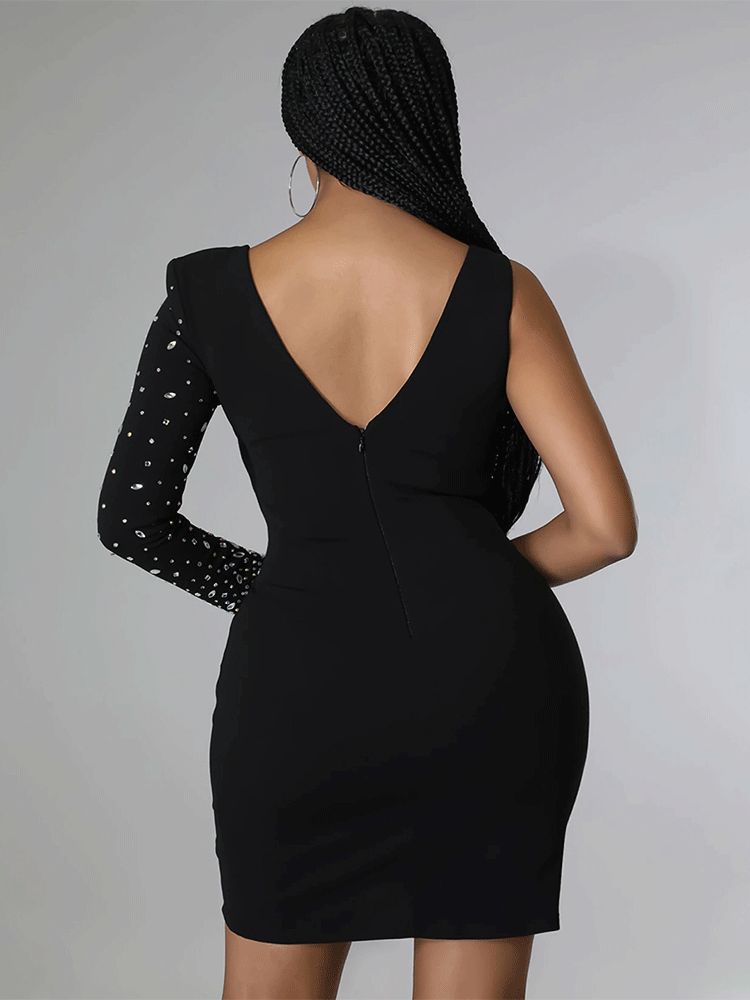 Back view of a woman wearing a black sheath dress with a V-neck and a long embellished sleeve.
