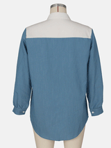 Back view of a colorblock shirt dress with appliqué patches displayed on a mannequin