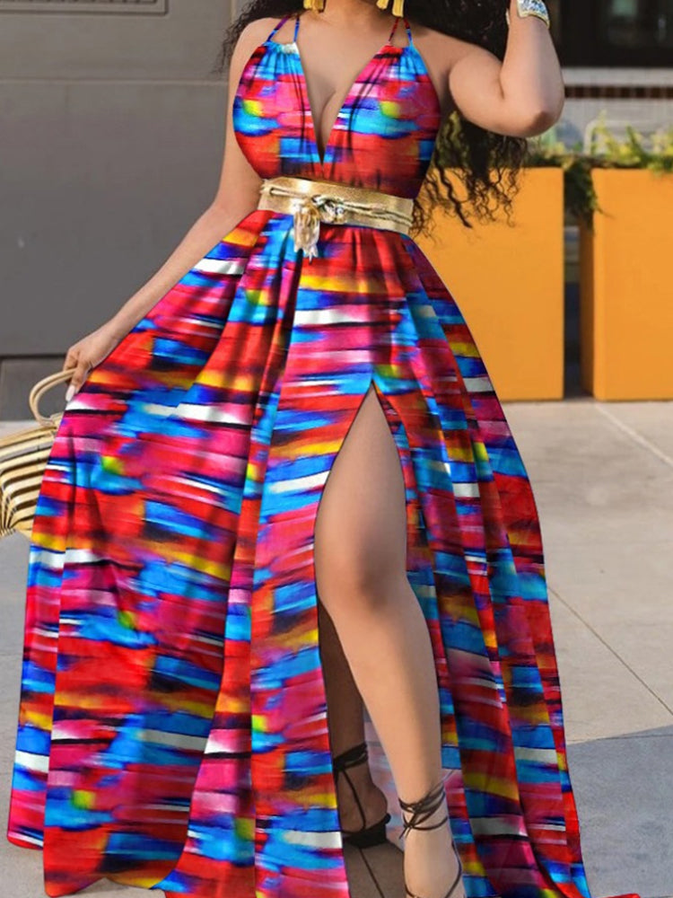 Woman wearing a vibrant striped print maxi dress with a gold belt and a high slit.