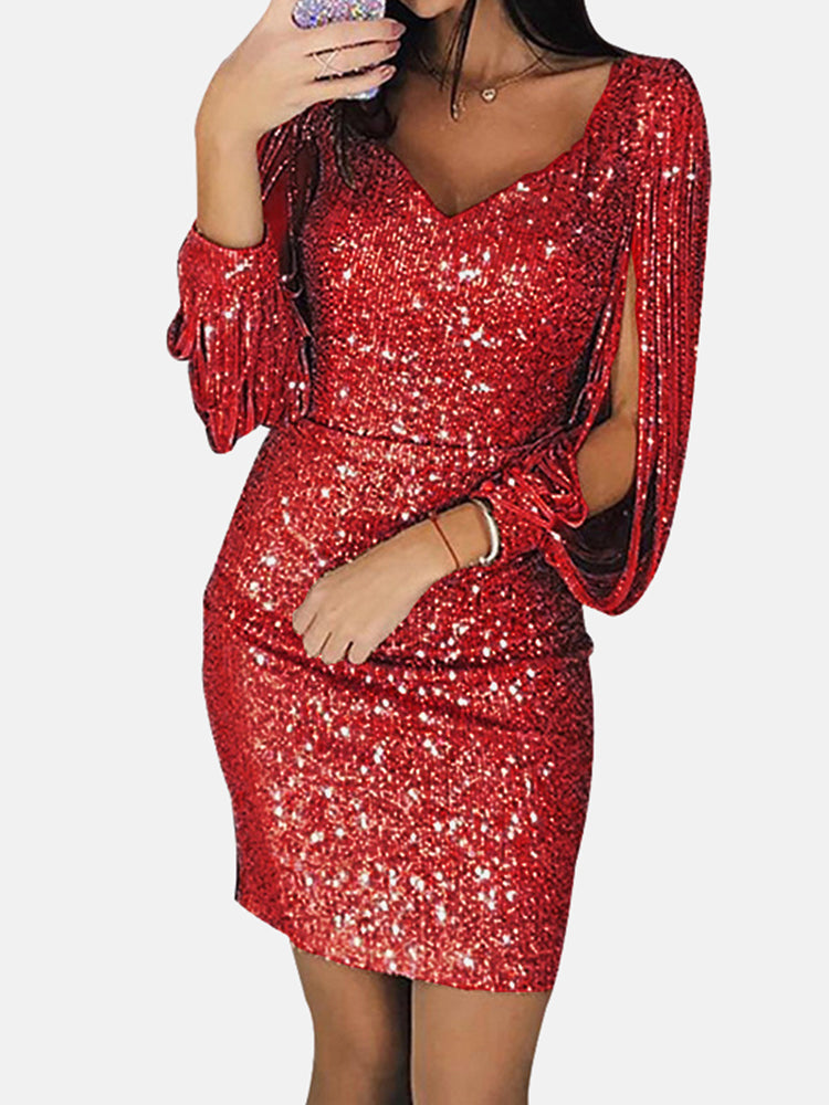 Woman wearing a red sequin dress with tassel sleeves