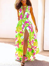 woman wearing a green floral print maxi dress with a deep V-neck and high slit