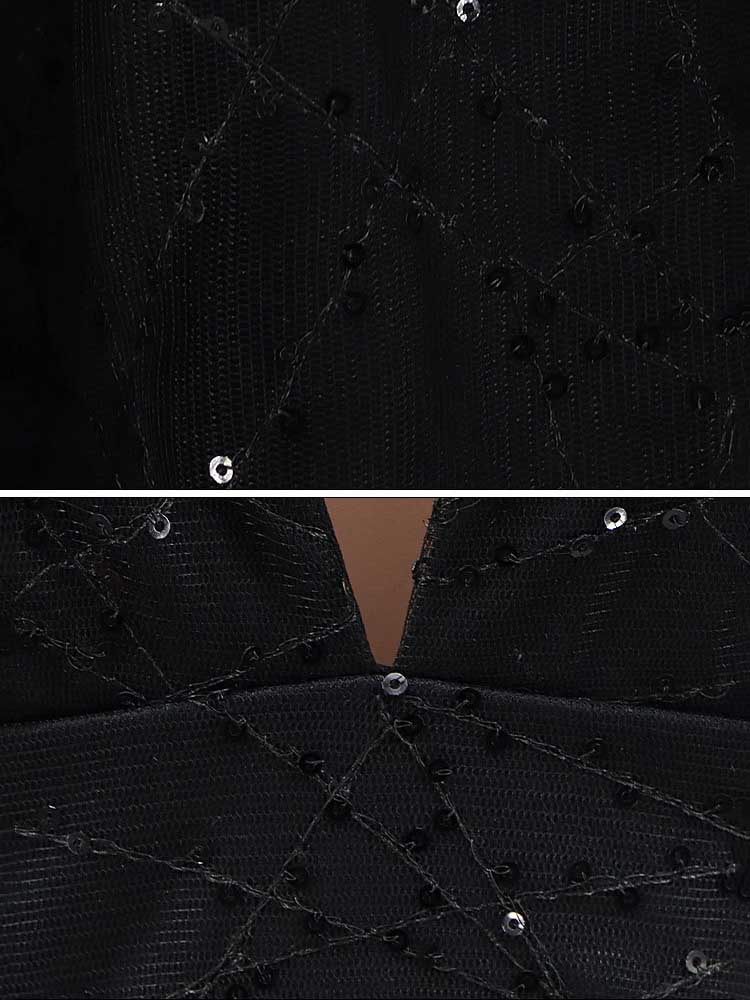 Close-up of the black fabric of the gown, showing the geometric pattern and sequin embellishments.