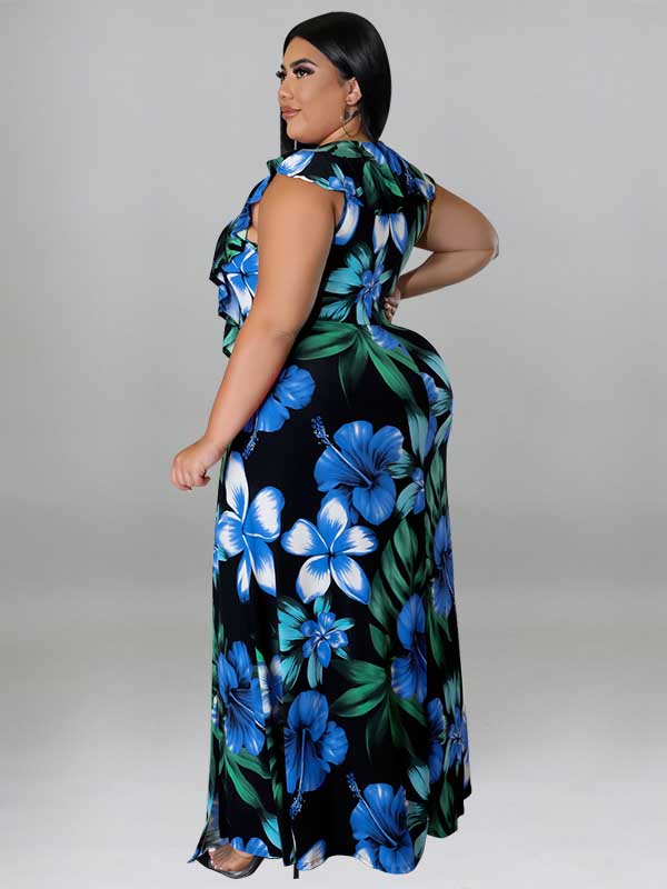 Side view of a woman in a black maxi dress with a blue and green floral print.