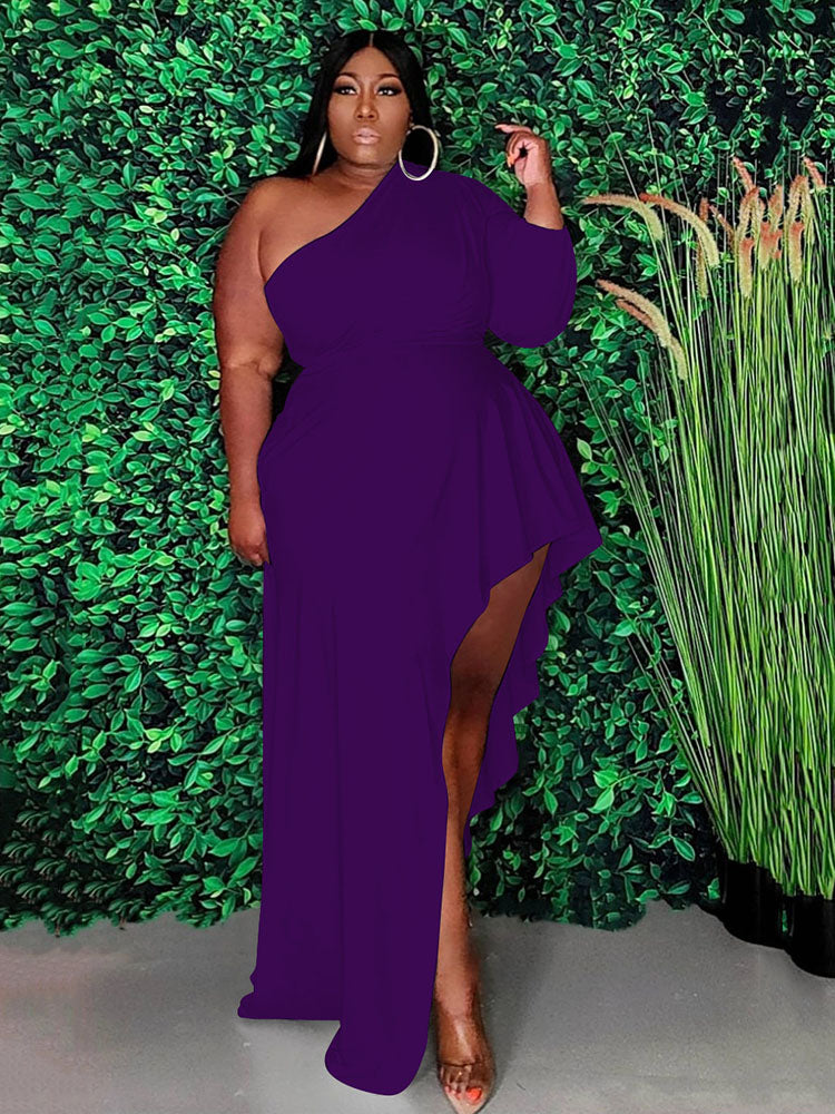 Woman wearing a purple one-shoulder maxi dress with an asymmetrical hemline and ruffle detail.