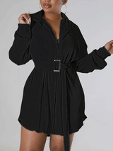 Woman wearing a black pleated shirt dress with a belt