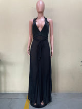 Mannequin displaying a black halter maxi dress with a deep V-neck, tie waist, and pleated skirt, shown from the front.