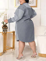 Side view of a woman wearing a navy and white striped long-sleeve shirt dress with a belted waist.