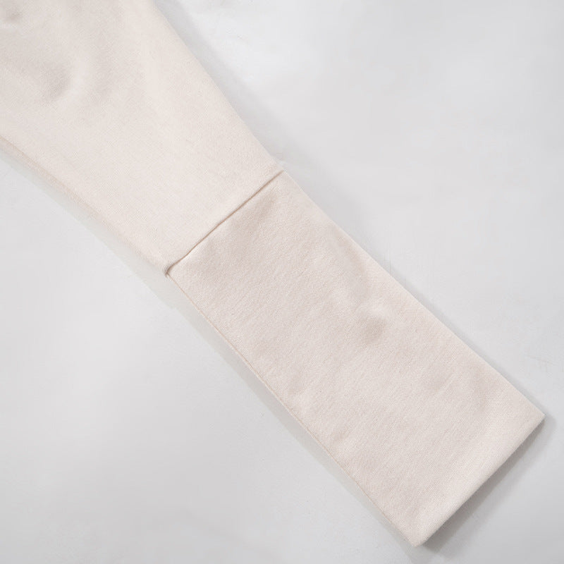 Close-up of the cuff of the long dolman sleeve on the off-the-shoulder mini dress.