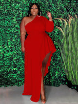 Woman wearing a red one-shoulder maxi dress with an asymmetrical hemline and ruffle detail.