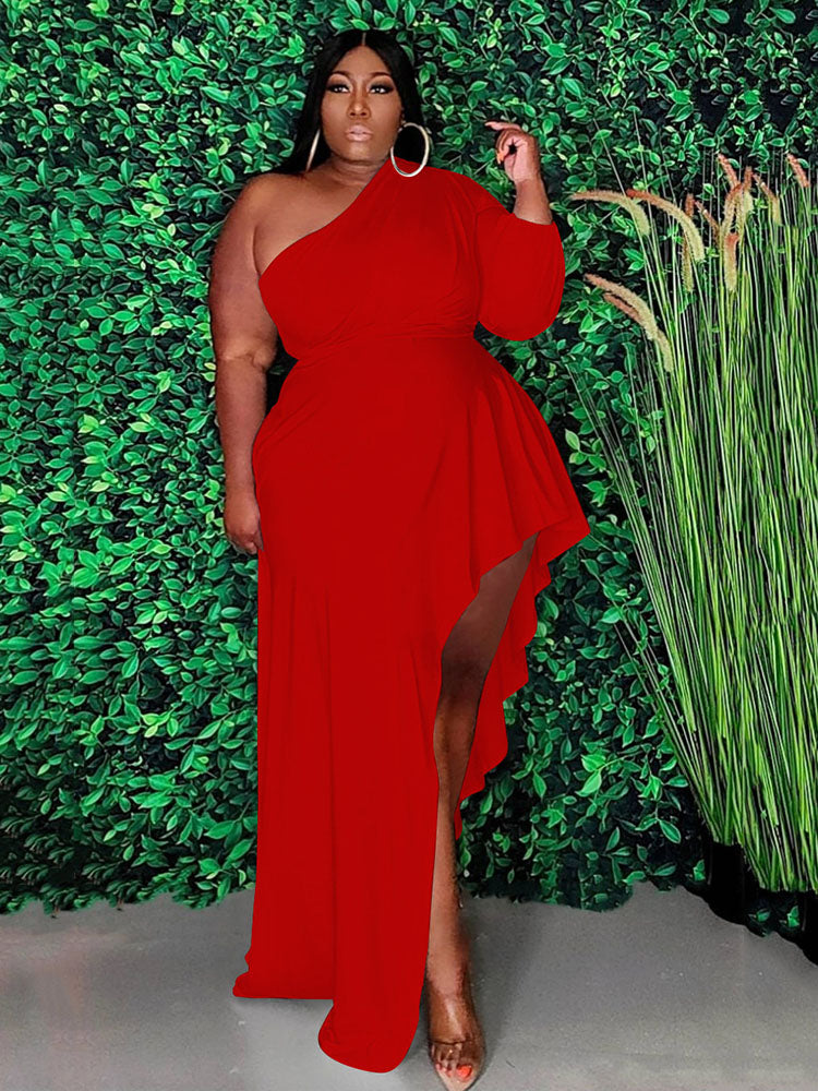 Woman wearing a red one-shoulder maxi dress with an asymmetrical hemline and ruffle detail.