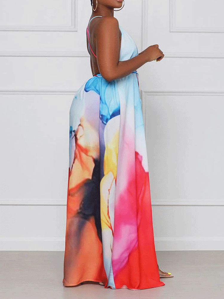 Side view of a woman showcasing the high slit and flowing skirt of an abstract print maxi dress.