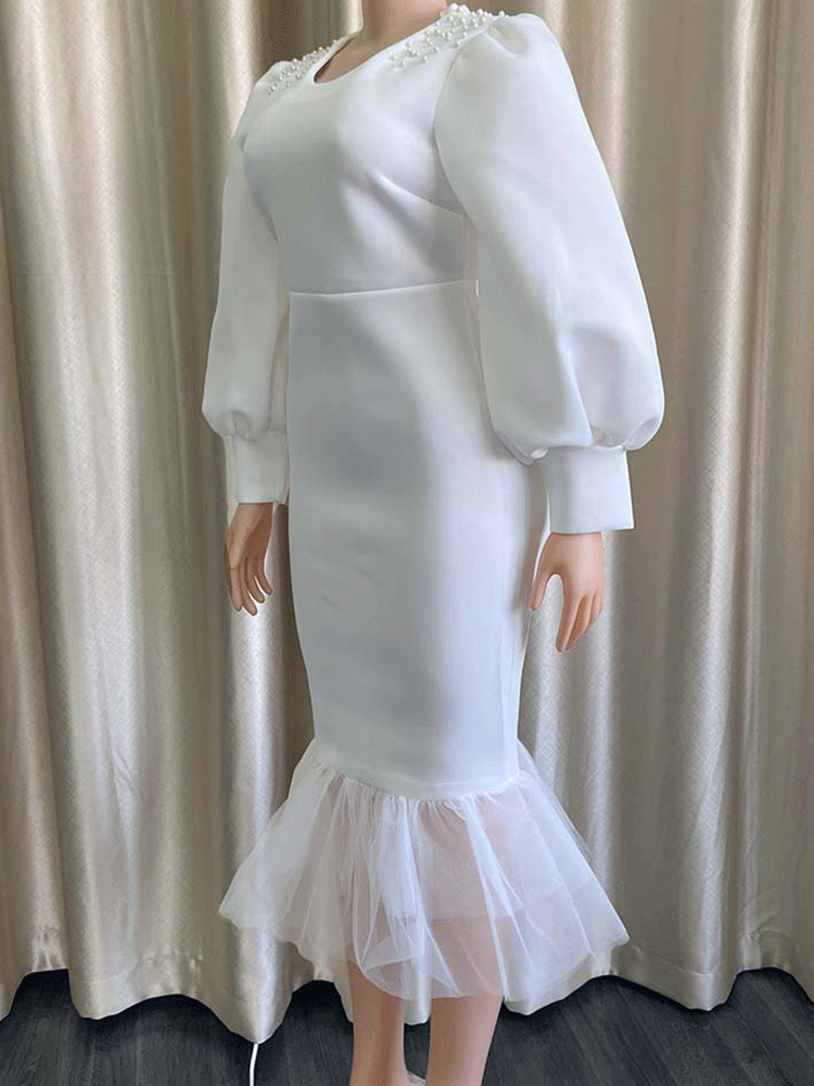 Side view of white puff sleeve dress on mannequin