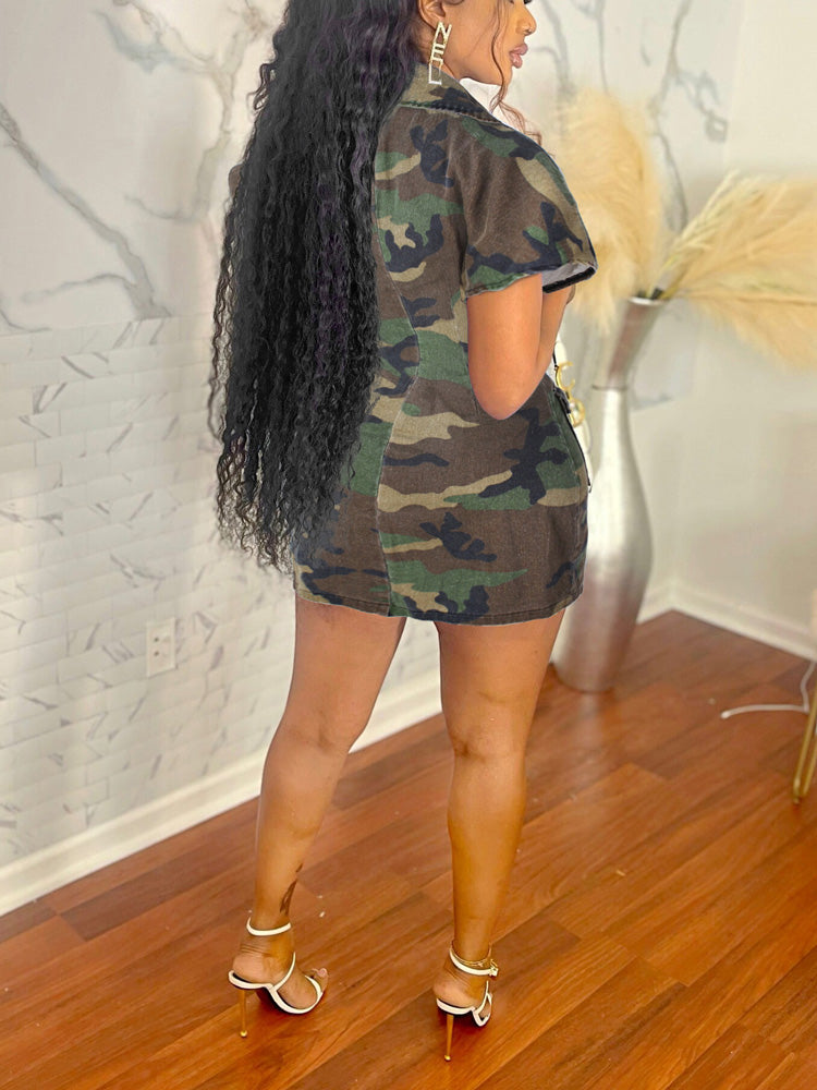 Back view of a woman wearing a camouflage print short sleeve button-down dress.