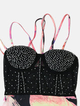 Detailed view of the embellished bodice and straps of a black mesh dress
