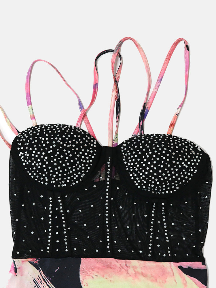 Detailed view of the embellished bodice and straps of a black mesh dress