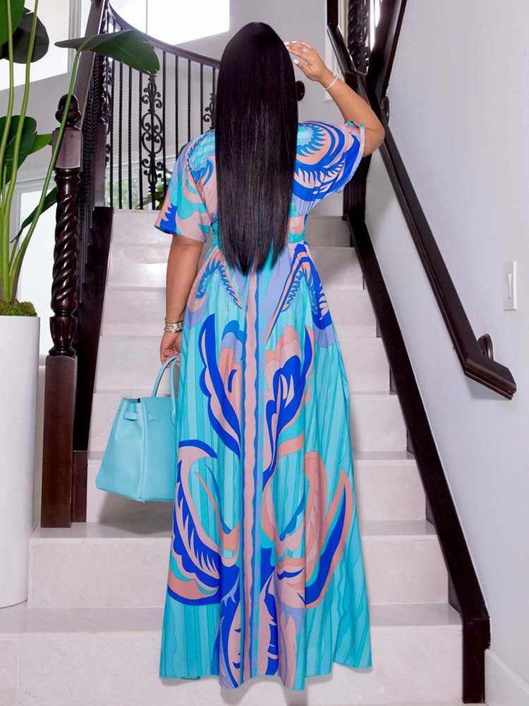 Back view of a woman wearing a blue and pink abstract print maxi dress.
