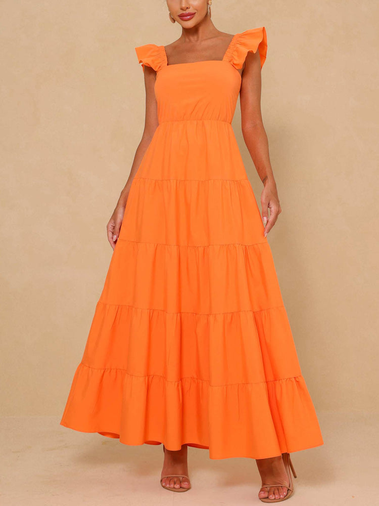 Woman wearing an orange tiered maxi dress with flutter sleeves and a square neckline, front view.