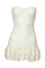 white lace strapless dress with ruffled hem on a mannequin
