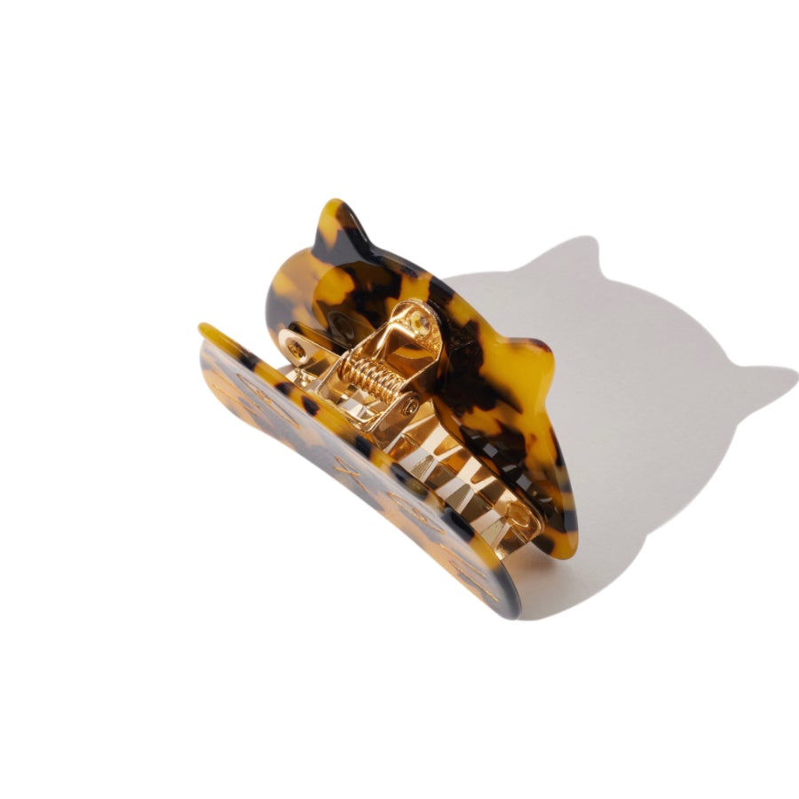 Close-up of tortoiseshell cat face hair claw clip showing metal hinge