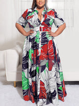 Woman wearing a floral print maxi dress with short sleeves and a collared neckline.