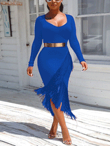 Woman wearing a blue long-sleeved midi dress with fringe detailing and a gold belt