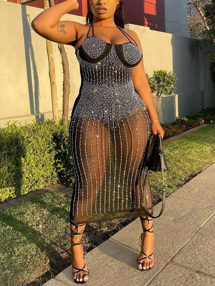 side view of a woman wearing a black embellished sheer midi dress
