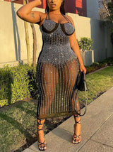 side view of a woman wearing a black embellished sheer midi dress