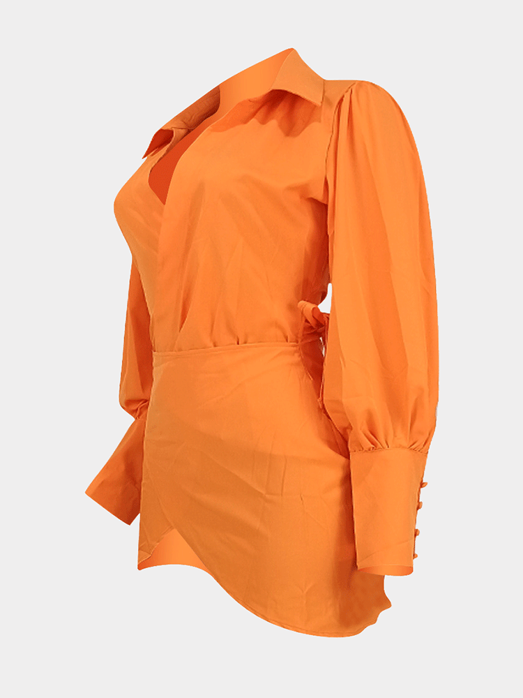 side view of an orange wrap dress displayed on a hanger