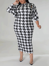 Plus size model posing in a black and white houndstooth print mock neck midi dress and a matching jacket