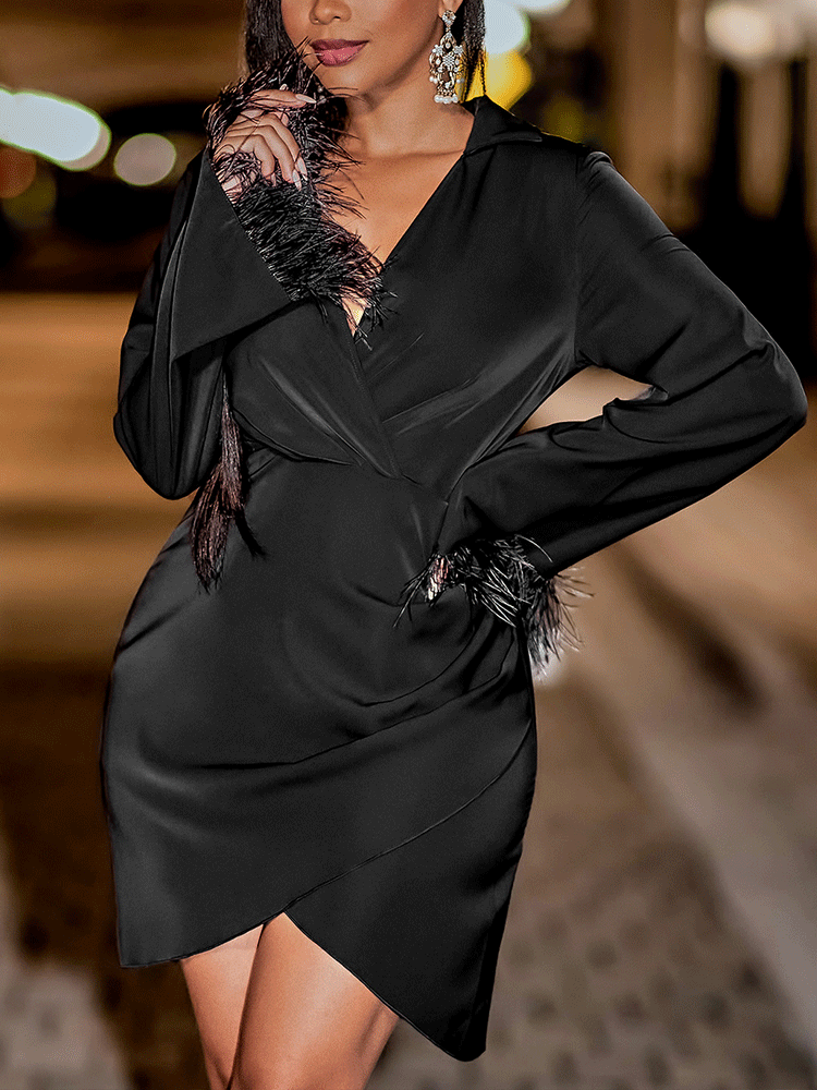 woman wearing a black satin dress with feather trim on the sleeves and neckline