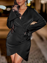 woman wearing a black satin dress with feather trim on the sleeves and neckline