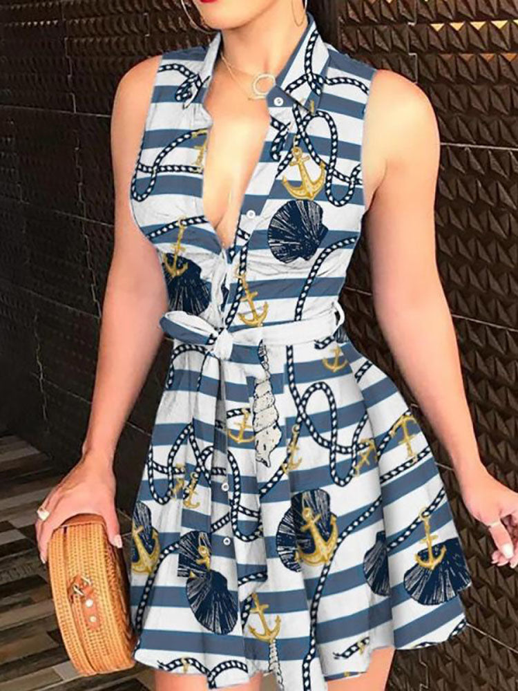 Woman wearing a sleeveless V-neck mini dress with a nautical print and tie waist.
