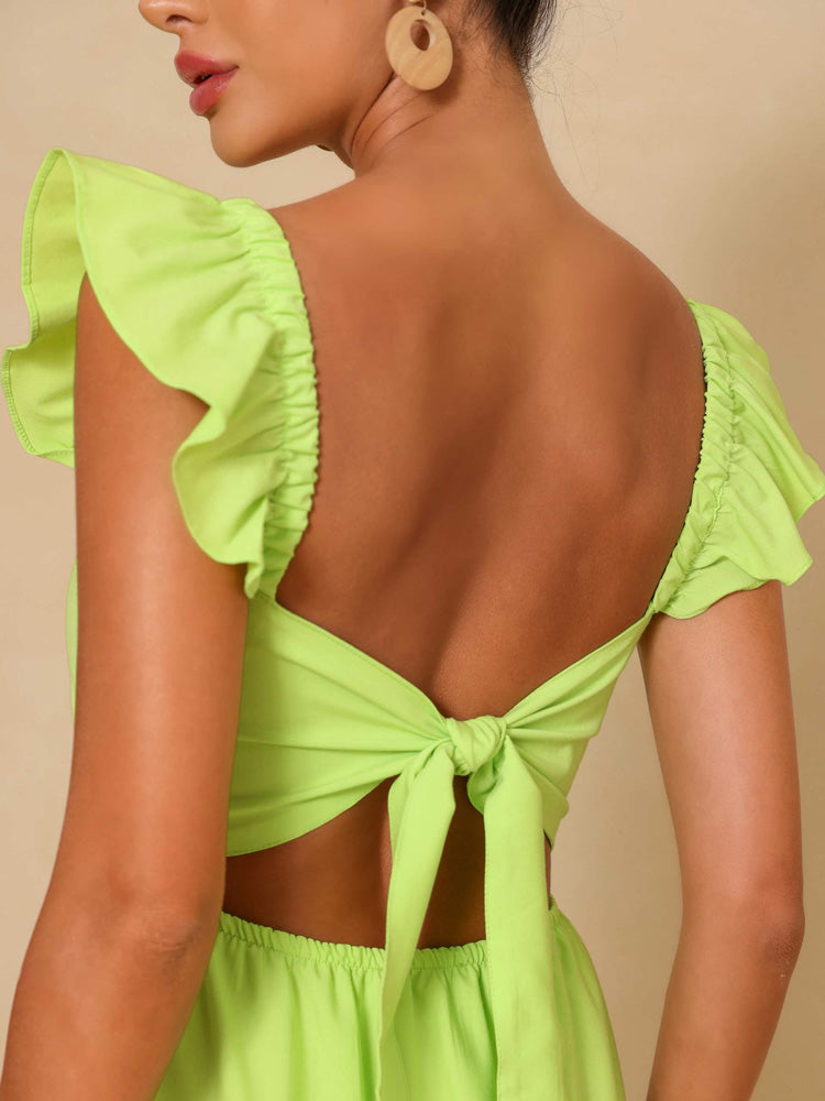 Close-up of the open back with tie closure of a lime green maxi dress.