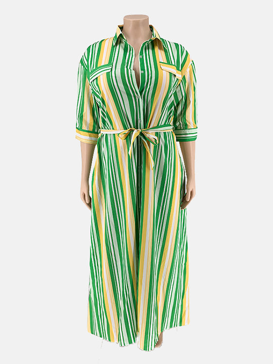 A green, yellow, and white striped maxi dress on a mannequin, featuring a collared neckline, button-down front, belted waist, and three-quarter sleeves.