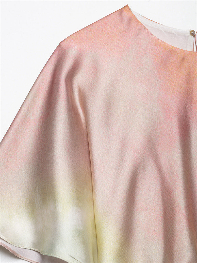close-up of the pink and yellow ombre satin fabric on the sleeve of a midi dress