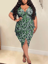 Plus-size woman wearing a green leopard print V-neck dress with short sleeves and an asymmetrical hem.