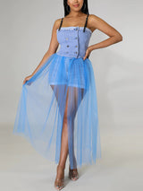Woman wearing a light blue denim corset top with a long, sheer light blue tulle skirt over denim shorts, front view.
