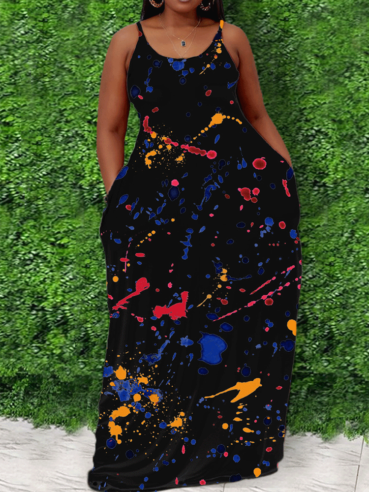 woman wearing a black maxi dress with multi-colored splatter print and spaghetti straps
