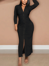 Woman wearing a black ruched button-down maxi dress with a high slit
