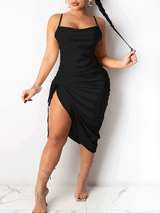 Woman wearing a black satin midi dress with spaghetti straps and a cowl neckline, featuring a drawstring side slit and ruched detailing.