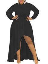 Woman wearing a black long-sleeved, high-low hemline dress.