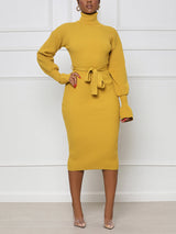 Woman wearing a yellow ribbed knit midi dress with a turtleneck and belt