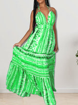 Woman posing in a long green tie-dye halter neck dress