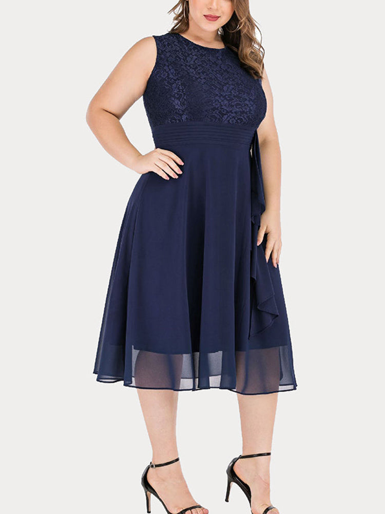 Woman wearing a navy blue lace and chiffon A-line knee-length dress with a round neckline and sleeveless design