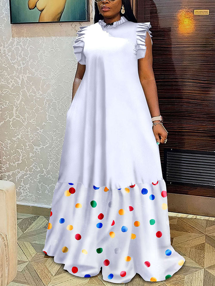 Woman wearing a white maxi dress with a polka dot print hem