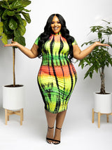 Plus-size woman in a colorful tie-dye bodycon dress with short sleeves and a mock neckline, standing with arms outstretched.