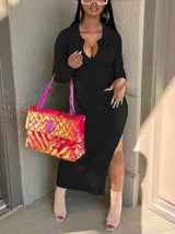 Woman wearing a black ribbed knit midi dress with long sleeves and a v-neck collar, accessorized with a pink sequined handbag and tan heeled boots.